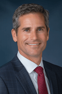 headshot of man in suit and tie