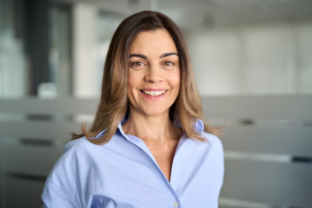 female headshot with office background